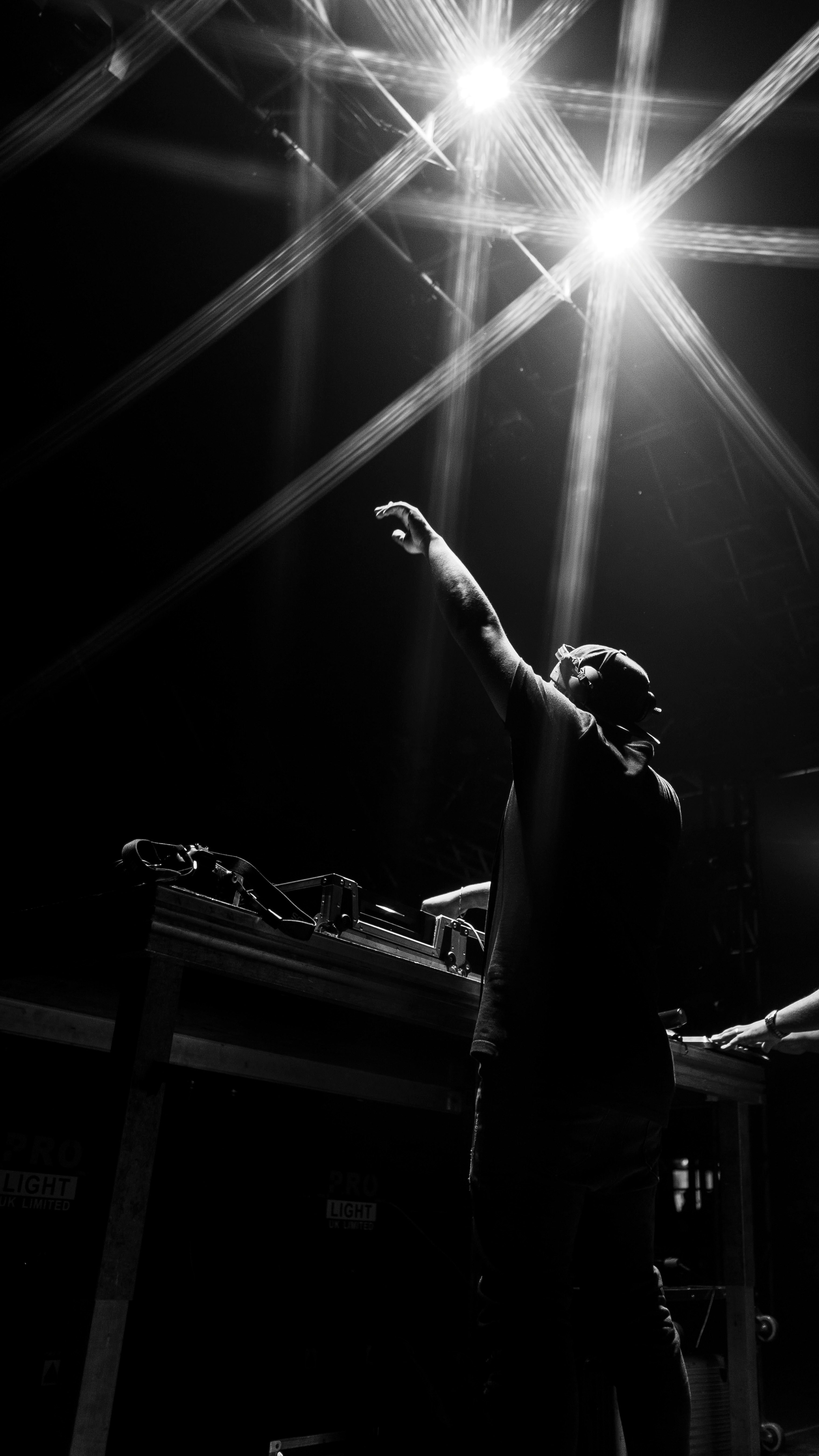 man in black t-shirt raising his hands